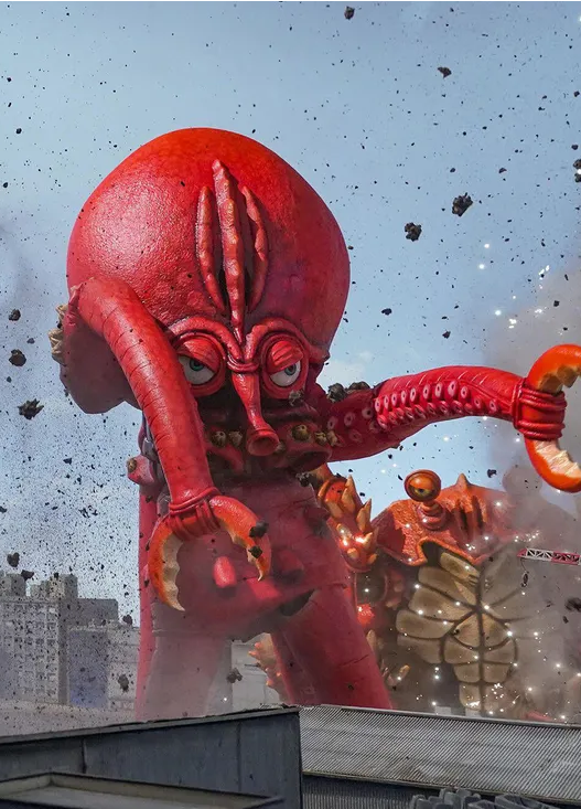 a still image from Monster Seafood Wars (2020) depicting an enormous lobster monster and crab monster towering above buildings and causing destruction